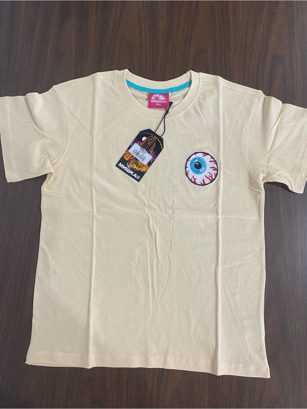 Mishka  Cream Eyeball Graphic Tee